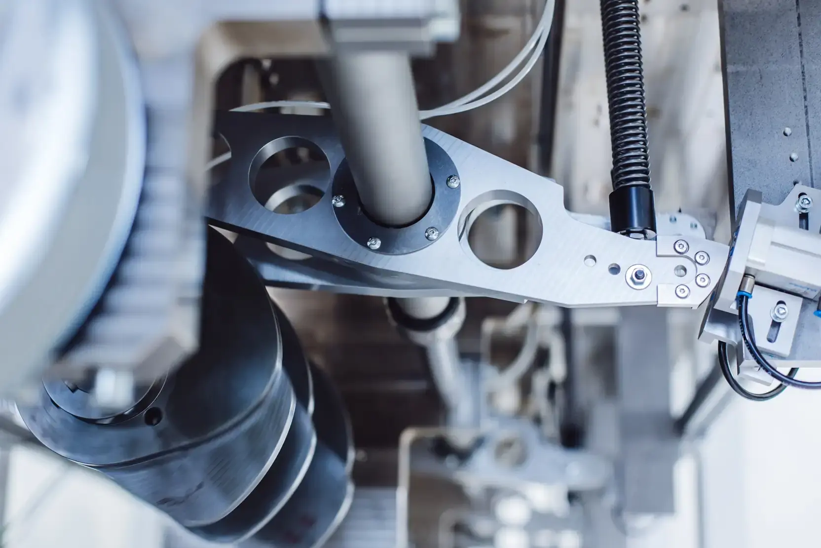 High-end CNC milled light-weight mechanical components with pneumatic connections and guide rods on an AWM custom machine.