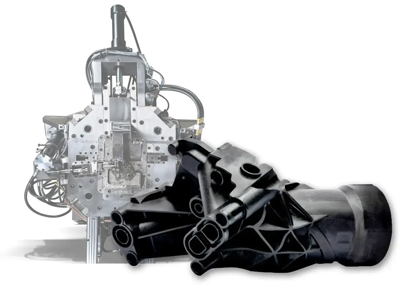 Comparison of an AWM injection mold with hydraulic connections and the resulting black molded plastic component.