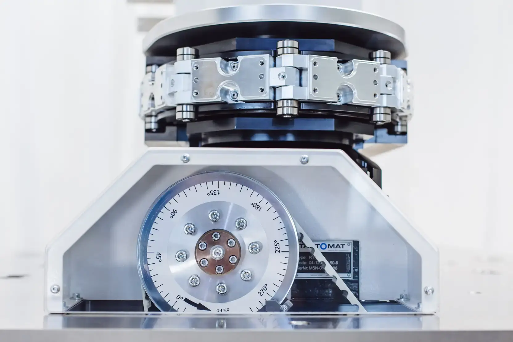 Precision assembly of an AWM custom machine featuring an angular scale and chain drive element.