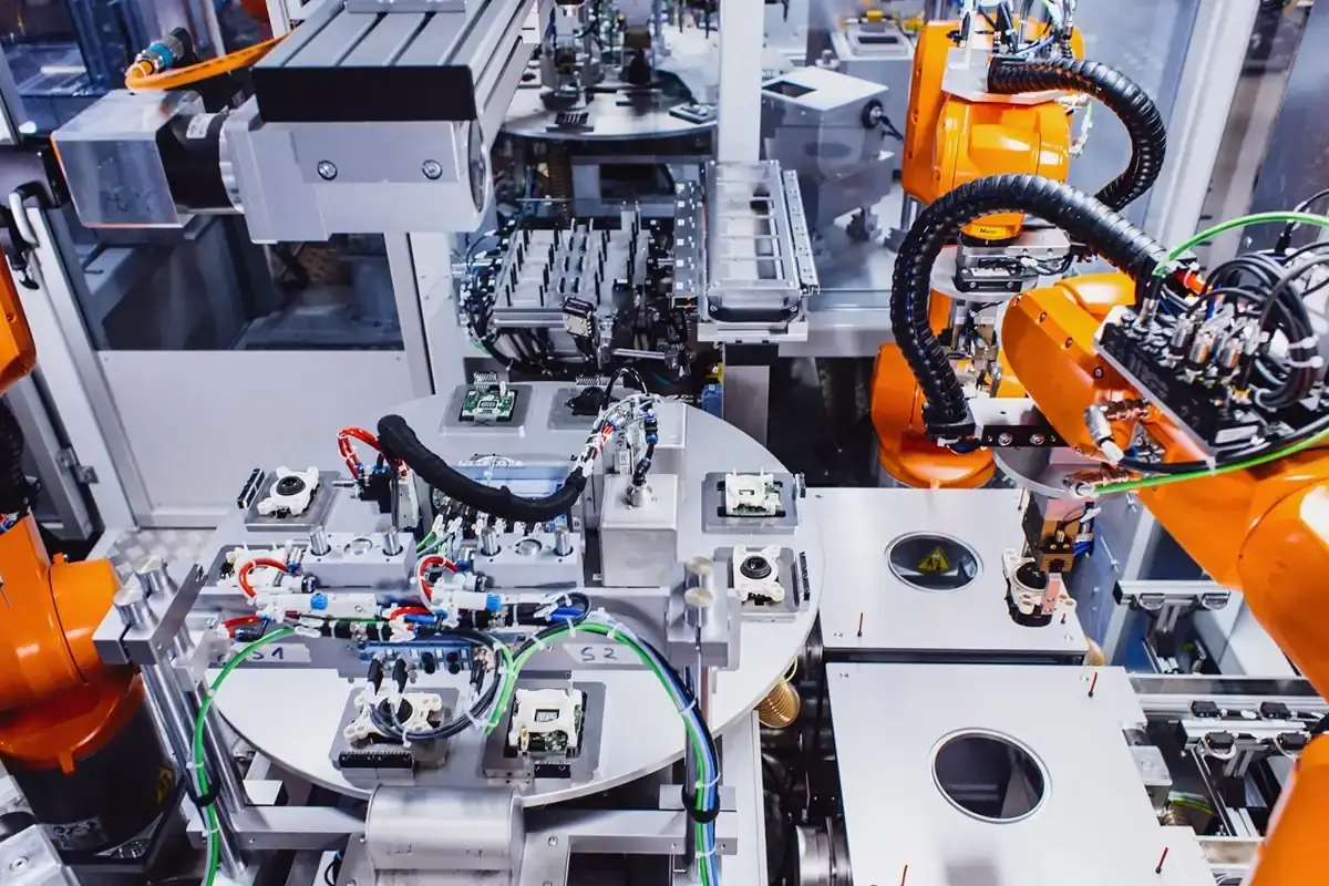Complex interlinked robotic assembly cell by AWM Arnstadt for the automated handling, joining, and quality inspection of automotive lighting systems.