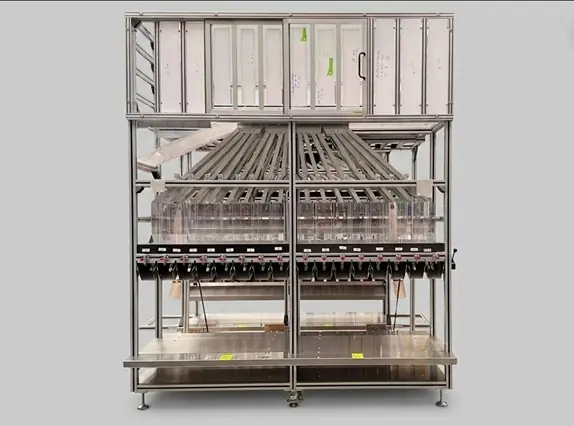 Front view of an isolated industrial separation station made of aluminum profiles with multi-stage guide channels on a gray background.